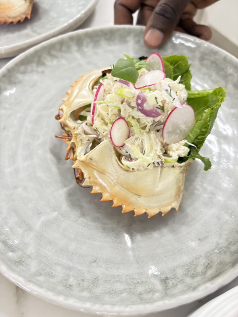 Crab salad served in the shell by chef Javi Puig, Tanzania